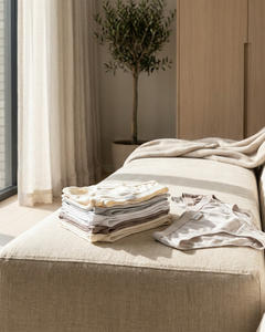 Neatly folded women’s Schiesser cotton briefs in soft neutral tones on a bright bedroom bench, styled with calm daylight and a premium editorial feel.