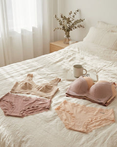 Soft beige and blush lace bralette and briefs displayed in a bright European bedroom, styled to highlight smooth comfort and elegant everyday wear.